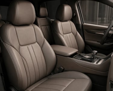 Luxurious brown leather car interior featuring premium front seats and center console.