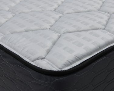 Close‑up of a mattress corner showing quilted top and stitched side panel.