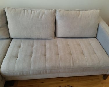 After cleaning showing a sofa visibly improved after deep cleaning.