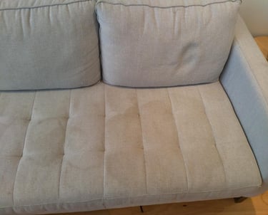 Before cleaning showing a sofa visible stain