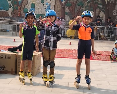 Young children wearing helmets and inline skates proudly display medals after a roller skating competition.