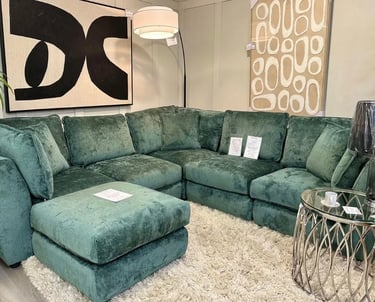 a couch with a green couch and a white rug