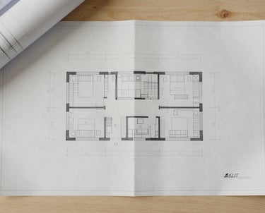 Overhead flat-lay of technical architectural blueprints on a clean wooden table, soft natural daylight, warm greige tones, minimal composition