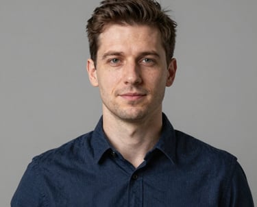 Clean, professional headshot of a developer in a modern studio. Neutral lighting, wearing a navy blue shirt. Eastern European / Ukrainian setting. Professional and reliable mood.