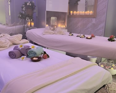 a couple of beds in a room with candles, spa, bienestar