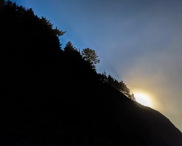 The sun peaks over the ridge in the coastal range of Oregon.