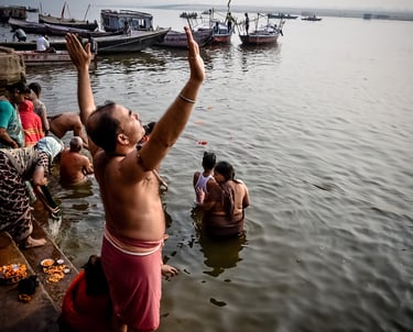 Early morning prayer to the sun and the waters of the Ganges in Varanasi, India.