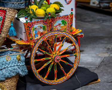 itahome  traditional Sicilian cart with fresh yellow lemons and decorative straw baskets.