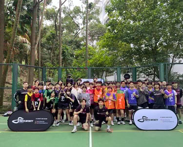 A diverse youth dodgeball team posing together for a group photo on an outdoor court with sports gear.