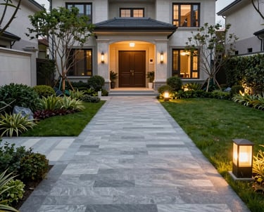 A beautifully crafted stone patio with warm lighting and comfortable seating under a twilight sky.