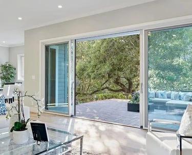 Living area with sliding glass doors opening to an outdoor deck.