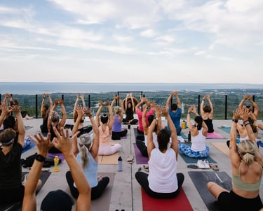 People practice yoga outdoors at sunset, at Everlove festival
