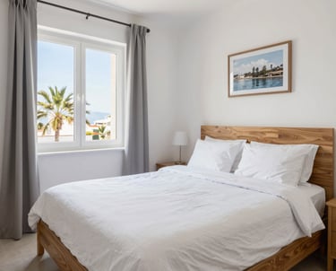 Bright, airy bedroom with neatly folded towels and fresh linens.