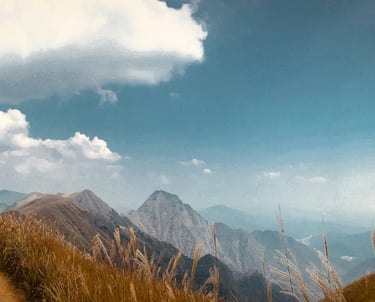 A pristine, open sky over the mountains, representing the freedom of authentic identity.