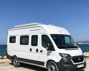 A skilled craftsman fitting custom interiors inside a motor caravan under warm natural light.