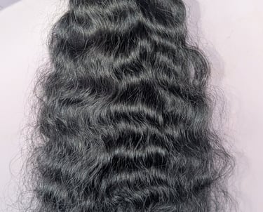 Wavy raw human hair bundles from Tanori Hair LLP prepared for wholesale export