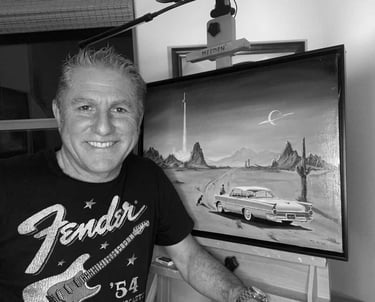 A black and white photograph of Marc Lee in front of his easel