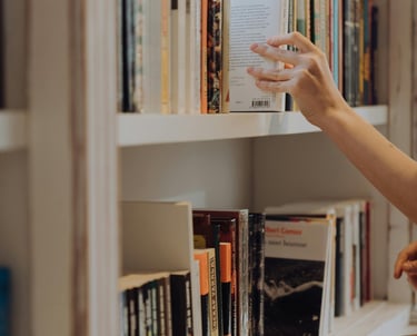 a scientist is placing at a book on a shelf