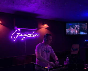 DJ BryanC2 mixing music and music videos at Gagootz bar.