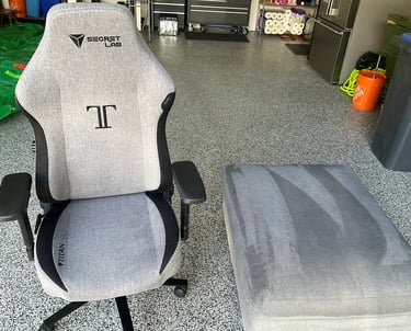 Finished result of our upholstery cleaning services on a chair and foot rest