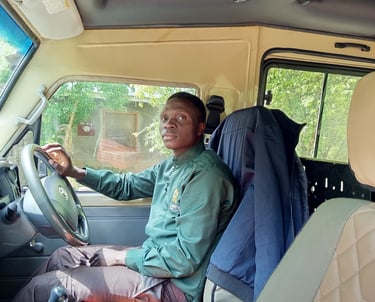 Professional Isra Safaris guide driving a custom safari vehicle during a Murchison Falls National Pa