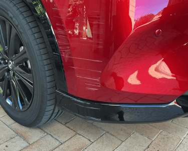Scratches and paint damage on the front bumper of a red Mazda before scratch repair Perth