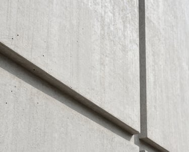 Details of architectural concrete and wood textures. Clean lines, minimalist photography in light gray and off white.