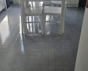 a kitchen with a table and chairs in the middle of the room