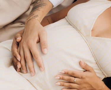 a man and woman laying on a blanket