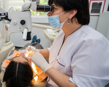Dentist performing dental treatment on patient in modern clinic in Tbilisi
