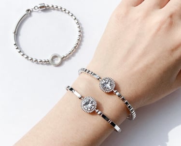 A collection of colorful imitation gemstone rings arranged on a wooden tray