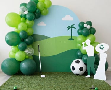 A vibrant inflatable golf simulator set up outdoors at a lively graduation party with guests enjoying the game.
