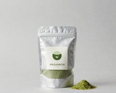 A close-up of custom-labeled matcha and wasanbon packages arranged neatly on a wooden table.