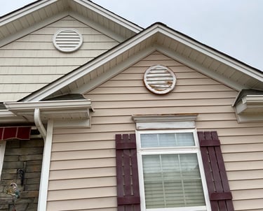 House with two round decorative circles before they were painted.