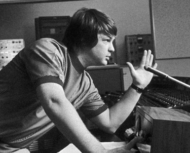 Brian Wilson of the Beach Boys works at a vintage mixing console in a recording studio.