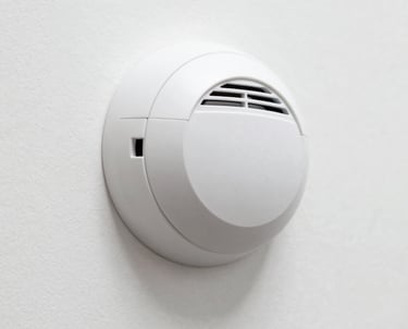 white smoke co detector on white wall