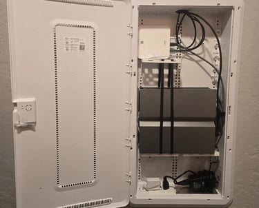 White recessed structured media enclosure with organized home networking equipment and cables.