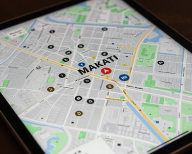 A close-up of a high-resolution tablet screen displaying a beautiful real estate map of Makati, showing property markers and high-end design.