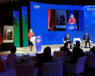 a group of people sitting at a podium with a speaker