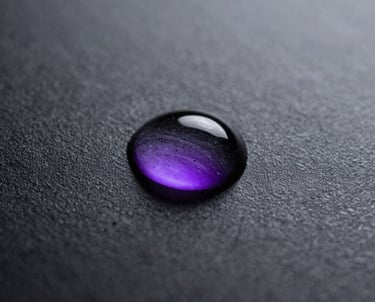 A macro shot of a single drop of water on a black metallic surface, reflecting a purple neon light. It symbolizes clarity, purity, and minimalist design.