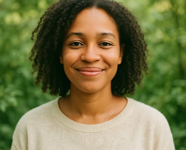 A smiling woman - natural curly hair, against a lush green backdrop, reflecting warmth, positivity