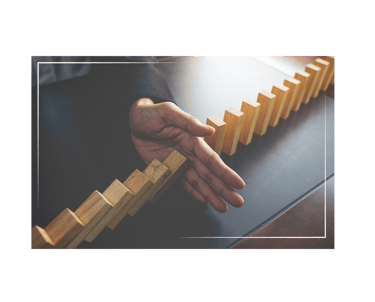 hand stopping blocks from falling over.