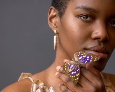 Portrait of woman holding a purple butterfly 