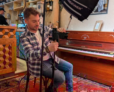 a man sitting in a chair with a camera and a camera