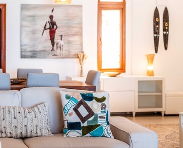 a living room with a couch and a table at Villa Serene in Zanzibar