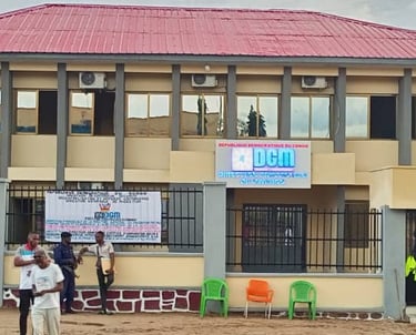 a group of people standing in front of DGM's building