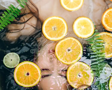 ( Asian ) woman in a bathtub with oranges and limes (body detox)