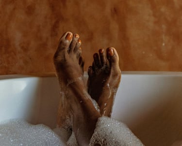 a person's feet in a bathtub with soap bubbles ( ionic foot detox )