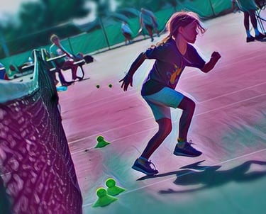 Little girl running on tennis court doing drill at tennis camp in Panama City Beach, FL.