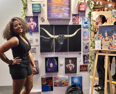 Alexis Peralta the artist standing in front of her wall of art at a gallery pancakes and booze